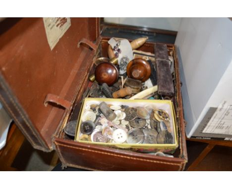 A brown leather case containing button, a cut throat razor, glass marbles etc. 