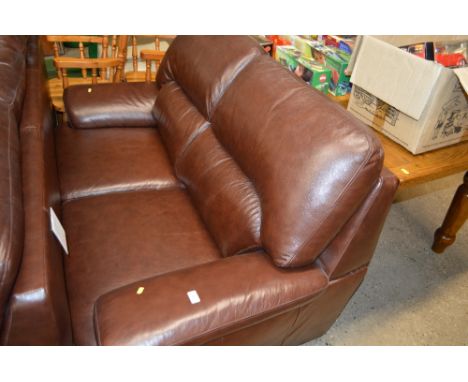 A brown leather two seater sofa