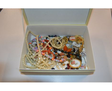 A box of various costume jewellery, necklaces, brooches etc. 