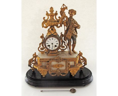 A French ormolu spelter and white marble mantle clock with a figure in 18th century attire on black ebonised platform, with p