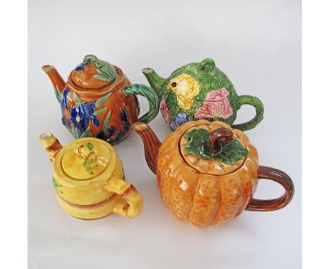 A collection of four ceramic tea pots. (8)