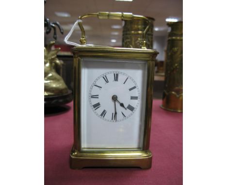 A Brass Cased Carriage Clock, white dial, Roman numerals, with carrying handle.