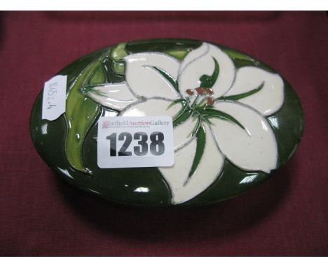 Moorcroft 'Bermuda Lily' Pattern Oval Shaped Trinket Box, with paper label "By Appointment, W. Moorcroft Potters to the Late 
