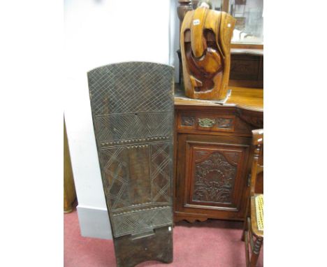 A Tribal Carved Hardwood Shield (?), decorated with incised stylised geometric motifs, height 117cm and a carved trunk sectio