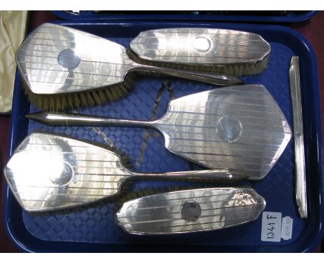 A Matched Hallmarked Silver Backed Five Piece Dressing Table Set, DM Co, Birmingham 1928, 1929, with matching comb mount :- O