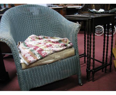 A Lloyd Loom Armchair; together with a nest of tables. (2)