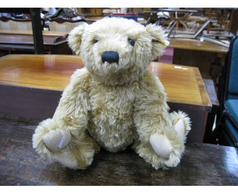 A Modern Steiff Teddy Bear, with poseable arms and legs, glass eyes, button to ear, 50cm high approximately.