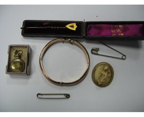 A Hinged Bangle, foliate engraved to the front, (damages) together with a shield shape stick pin, carved oval brooch etc.