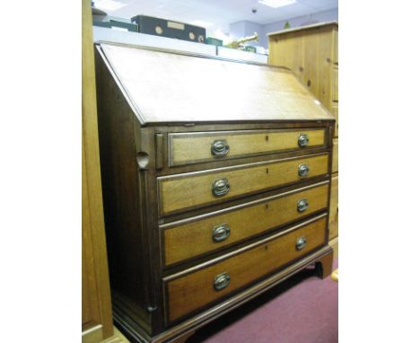 A Late XVIII Century Oak and Mahogany Bureau, with blind fretwork, fitted interior, fall front over four graduated drawers, o