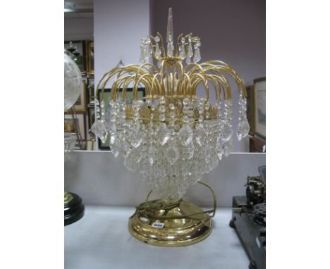 A Focus Table Lamp, with faceted obelisk finial, and lustre drops to many sprouting gilt metal branches, on circular stepped 