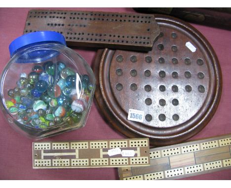 A Mahogany Solitaire Board, moulded edge on three squat bun feet, a sweet jar of marbles and three cribbage boards.