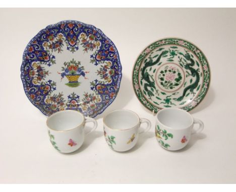 A collection of three 19th century Meissen type cups with painted bird and insect decoration with divided handles, together w