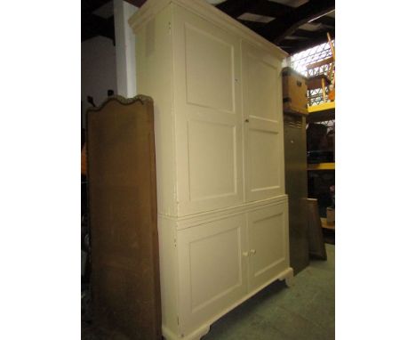 A Georgian linen cupboard with later painted finish, the upper section enclosed by a pair of twin panelled doors, the lower s