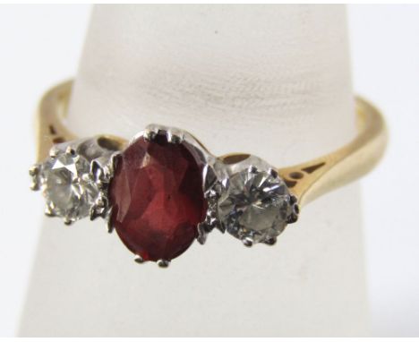 An almandine garnet and diamond three stone ring in white gold setting and 18ct gold shank. Size P, 3.5g