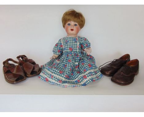 Bisque headed doll with articulated wooden limbs, back of the neck marked Germany, with shutting eyes and open mouth; togethe