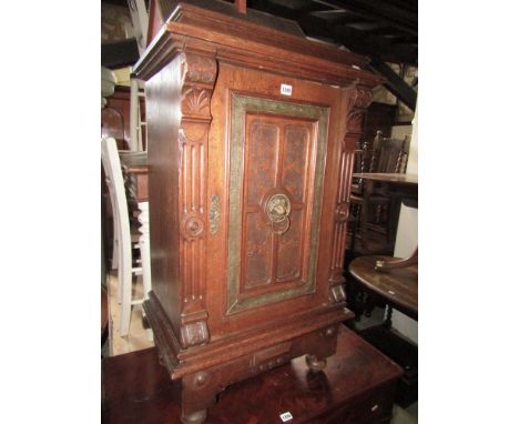 A 19th century mahogany side cupboard the door with 1/4 panel detail, lion mask and ring handle, flanked by reeded columns on