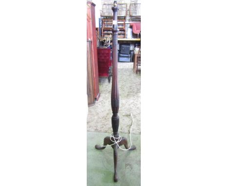 A 19th century mahogany torchere lamp standard on a carved tripod base