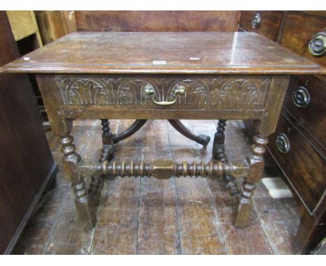 An 18th century and later oak side table fitted with a single frieze drawer raised on turned supports and with bobbin shaped 