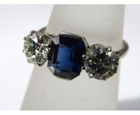 A platinum, diamond and sapphire three stone ring with central sapphire flanked by two diamonds approx 0.50ct each, size K, 3