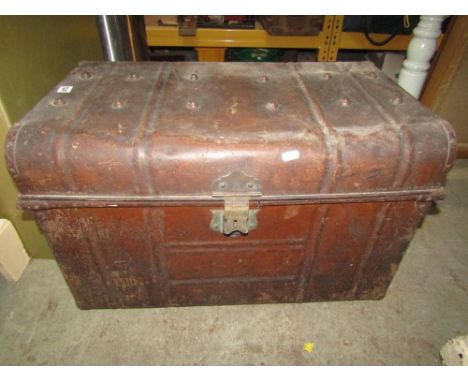 An old steel trunk containing a collection of vintage hand tools, blow torches, jack etc