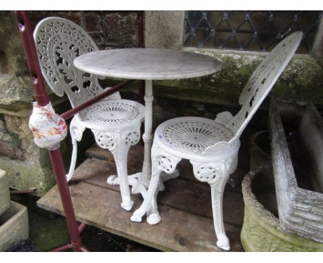 A cream painted heavy cast iron pub/bistro table with reeded column and shaped tripod beneath a circular white marble and gre