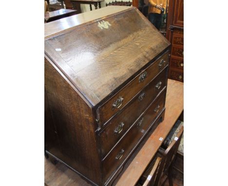 A George III writing bureau, the interior of simple form enclosed by drawers and cupboards, raised on bracket supports
