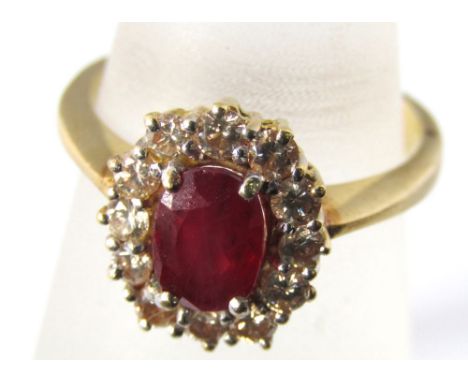 A ruby and diamond cluster ring marked 750, size O, 5.5g