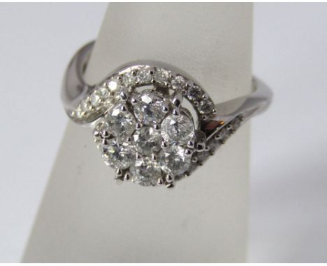 An 18ct white gold ring set with 29 diamonds in a twisted setting, size L/M, 4.5g