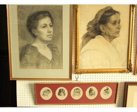 An early 20th century pencil and charcoal study of a shoulder length portrait of a female character with earrings and head sc