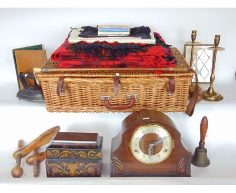 A wicker basket containing a collection of miscellaneous items to include two train mantle clock, Victorian style papier mach