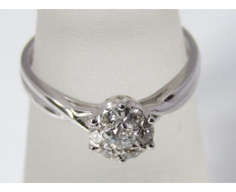 An 18ct white gold and diamond daisy ring with twisted shoulders, size P 2.5g