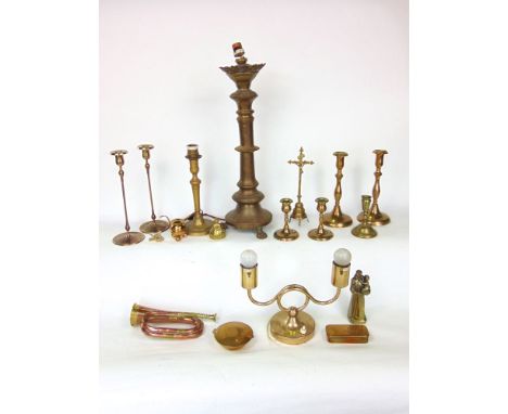 A large quantity of brassware, mainly candlesticks and lighting together with a bugle, trinket box, etc.