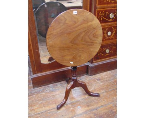 A small Georgian mahogany snap top table, the 50cm diameter top raised on turned pillar and tripod base