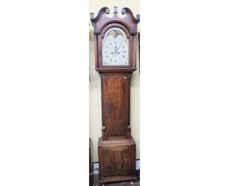 A Georgian oak longcase clock with canted corners, the hood with tapering column supports and swan necked pediment enclosing 