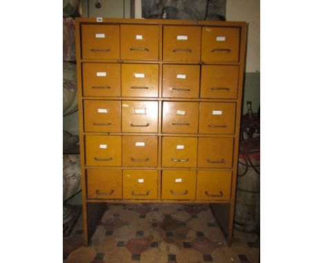 A vintage industrial bank of twenty index filing drawers with D shaped handles and later mustard coloured painted finish, 96 