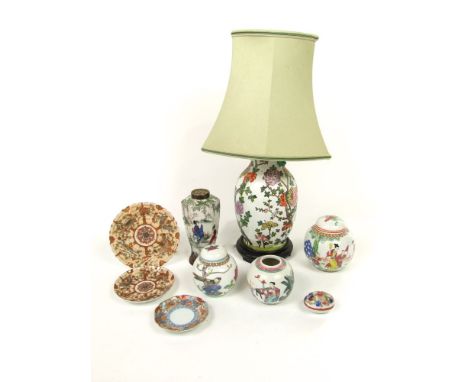 An oriental lamp base with polychrome painted floral and tree decoration with green shade, three ginger jars, a vase of hexag