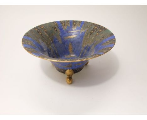A Carltonware blue ground bowl of flared form with painted and gilded forest tree decoration, raised on three gilded supports