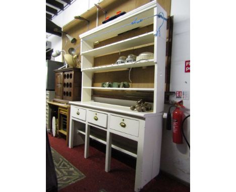 An old pine kitchen  dresser with painted finish, the base fitted with three frieze drawers raised on square cut and moulded 