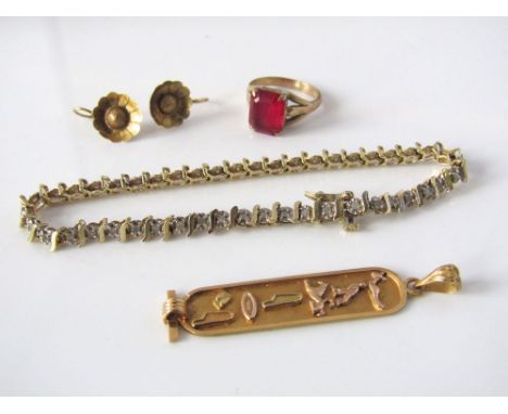 A collection of yellow metal items including a bracelet set with white stones, a pendant with Egyptian hieroglyphics, a 9ct p