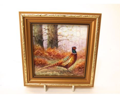 A ceramic plaque in the Royal Worcester manner with painted pheasant detail signed N Preed, 9cm square approx in gilt frame