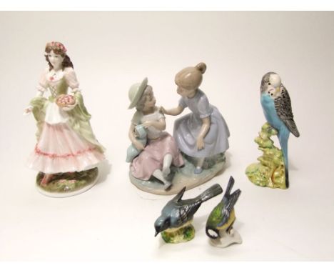 A Beswick model of a budgie with impressed number to base 216, a Royal Worcester figure, The Queen of the May, a Nao group of