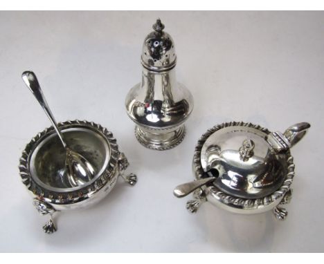 Good quality three piece cruet set in the Georgian manner, with gadrooned rims and lion mask and paw feet, comprising salt, p