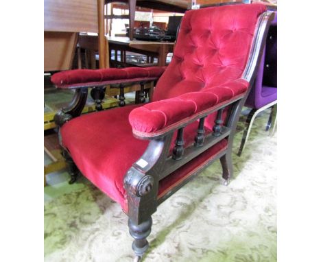 A Victorian mahogany library or drawing or drawing room chair with upholstered seat, button back and arms raised on turned fo