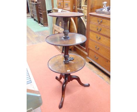 A Georgian mahogany three tier graduated buffet/dumb waiter, the two bottom tiers revolving, raised on a turned and wrythen f