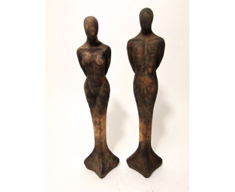 A pair of unusual art deco pottery figures of stylised male and female characters in standing pose with incised monogram R D 
