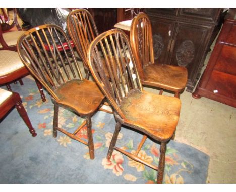 Three 19th century Windsor hoop and stick back kitchen chairs principally in elm and ash raised on splayed turned supports un