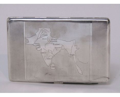 Novelty Indian cigarette case with engine turned decoration, the hinged lid engraved with a map of the Indian sub-continent, 