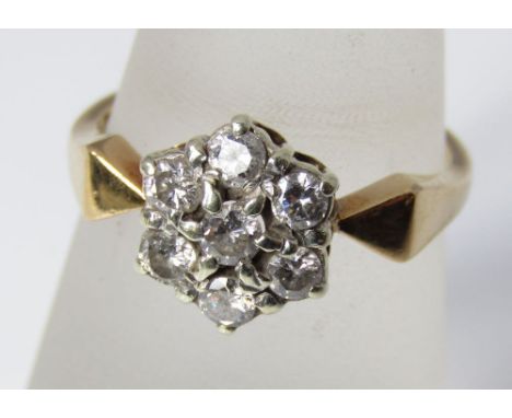 A yellow metal and diamond flower head ring marked VO, size P/Q, 4g