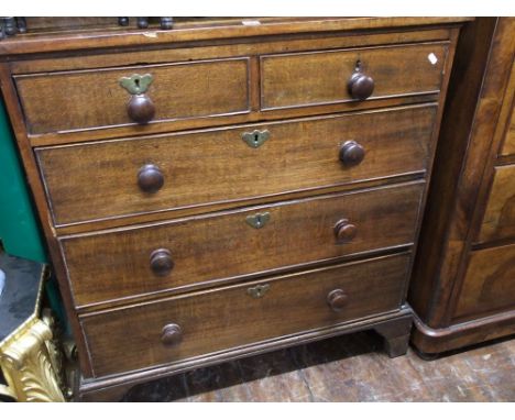 A Georgian oak country made chest of three long and two short drawers cross banded in walnut raised on bracket supports, 95cm
