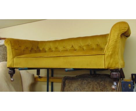 An Edwardian Chesterfield button back sofa with scrolled arms raised on turned supports, 183 cm approx